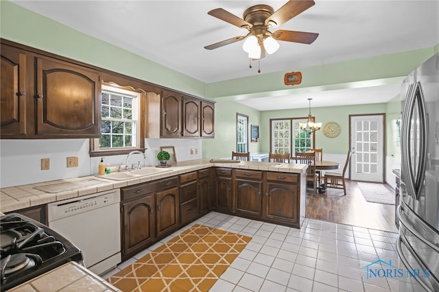 5605 Weckerly Rd, Whitehouse, OH 43571 - kitchen featuring freestanding refrigerator, tile countertops, a sink, and dishwasher