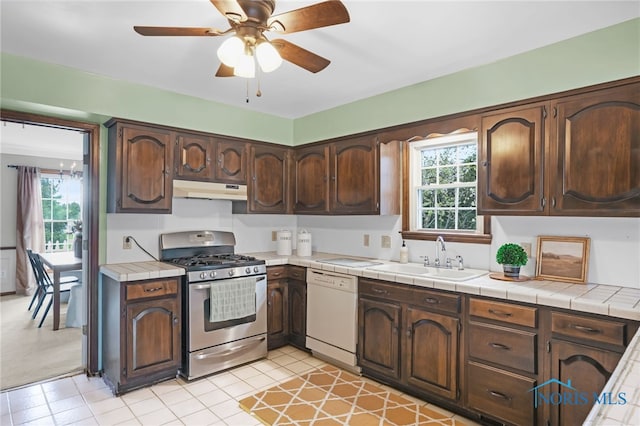 5605 Weckerly Rd, Whitehouse, OH 43571 - kitchen with white dishwasher, ceiling fan, a sink, stainless steel range with gas stovetop, and under cabinet range hood