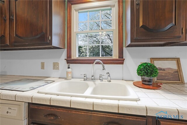 5605 Weckerly Rd, Whitehouse, OH 43571 - kitchen featuring dark brown cabinets, tile countertops, and a sink