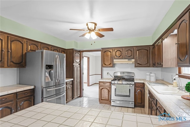 5605 Weckerly Rd, Whitehouse, OH 43571 - kitchen featuring tile counters, a sink, appliances with stainless steel finishes, and under cabinet range hood