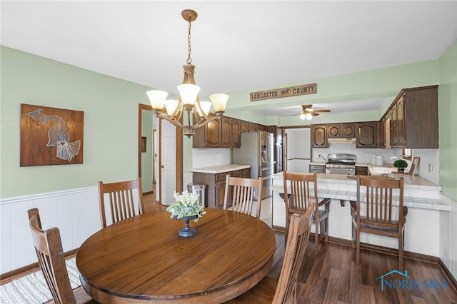 5605 Weckerly Rd, Whitehouse, OH 43571 - dining room with ceiling fan with notable chandelier and dark wood-style floors