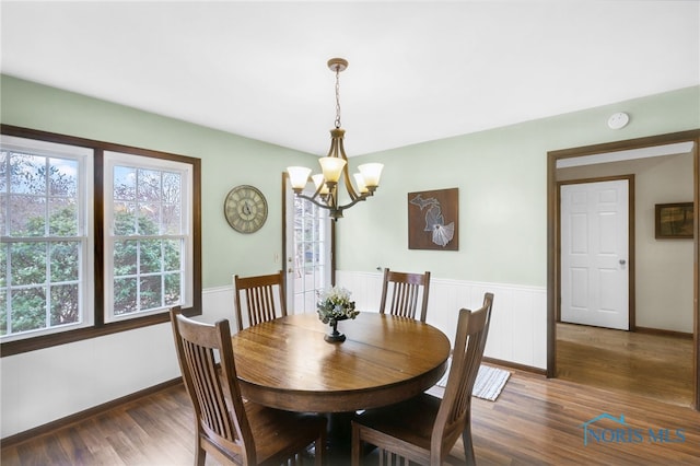 5605 Weckerly Rd, Whitehouse, OH 43571 - dining space with baseboards, wood finished floors, and a notable chandelier