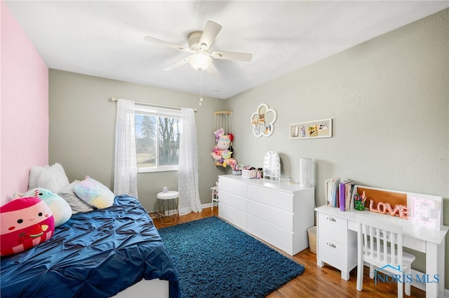 bedroom with ceiling fan and wood finished floors