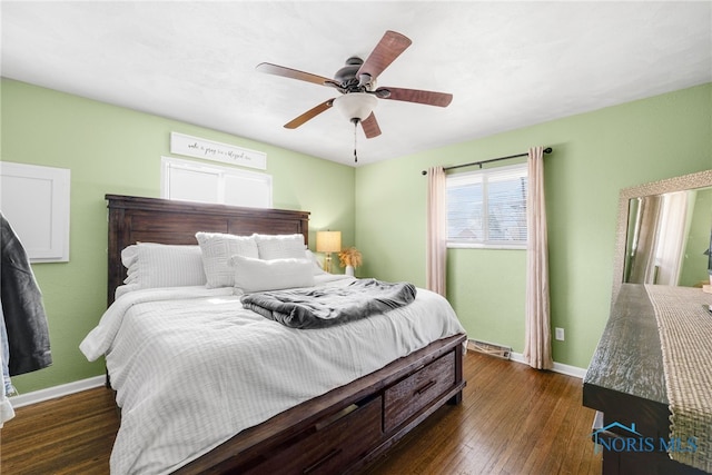 bedroom with ceiling fan, baseboards, and wood finished floors