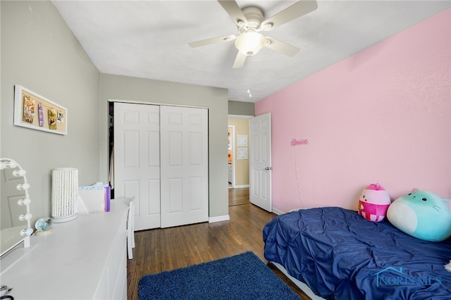 bedroom with ceiling fan, a closet, wood finished floors, and baseboards