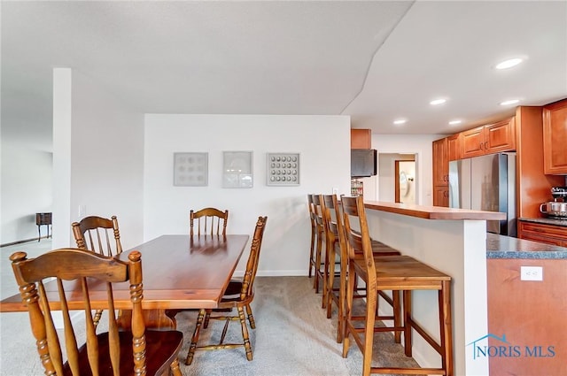 dining room featuring recessed lighting, baseboards, and light colored carpet