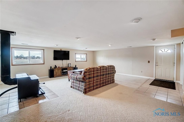 tiled living area with plenty of natural light, carpet flooring, and baseboards