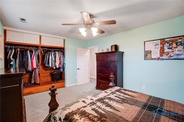 bedroom with carpet flooring, visible vents, baseboards, a ceiling fan, and a closet