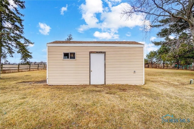 view of outbuilding with an outbuilding and fence