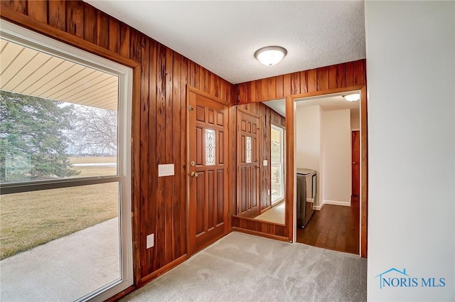 interior space with wooden walls and a textured ceiling