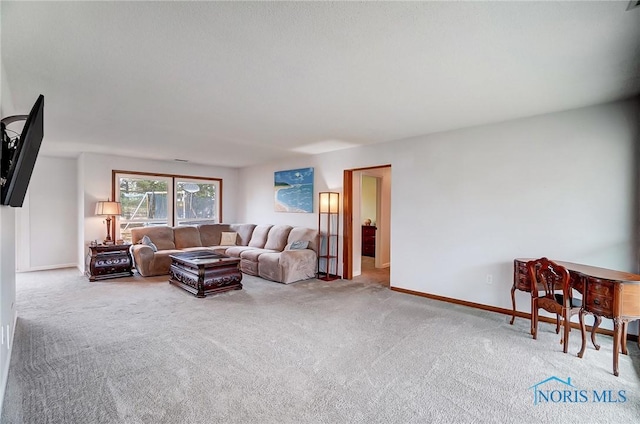 carpeted living room featuring baseboards