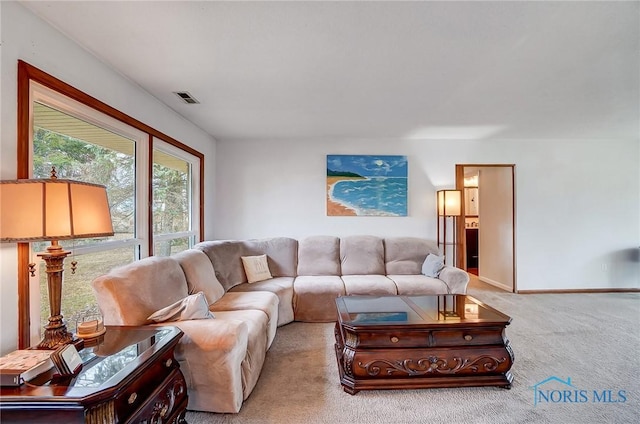 carpeted living room featuring baseboards and visible vents