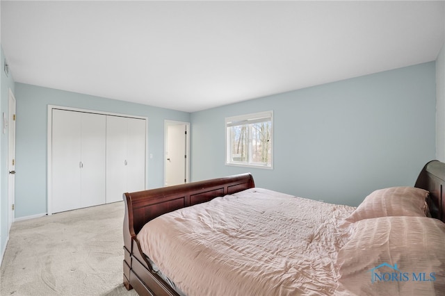 bedroom with a closet and light colored carpet