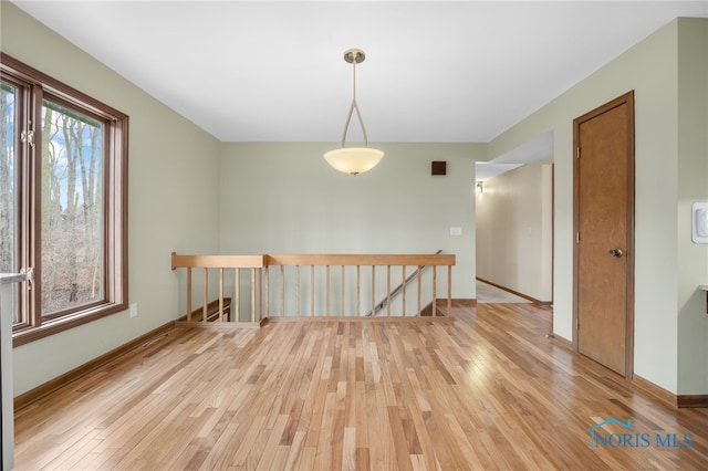 empty room featuring light wood-style flooring and baseboards