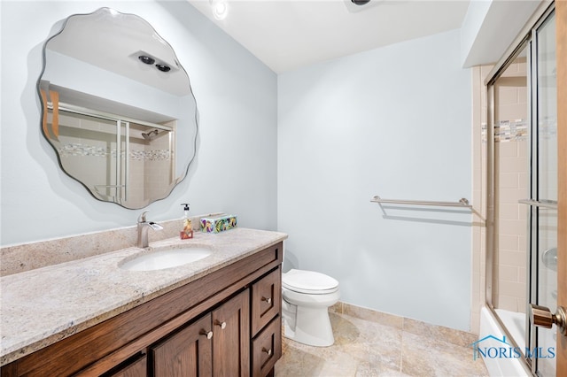 bathroom with toilet, enclosed tub / shower combo, and vanity