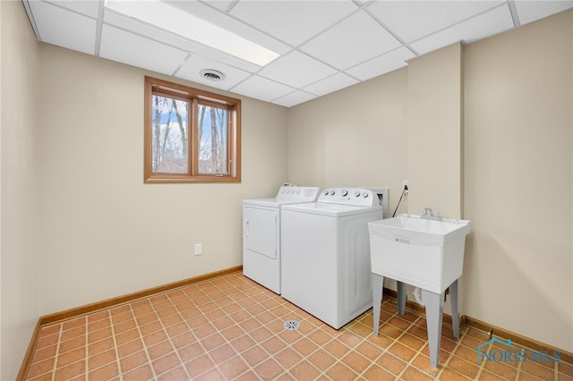 clothes washing area with laundry area, baseboards, visible vents, and washer and dryer