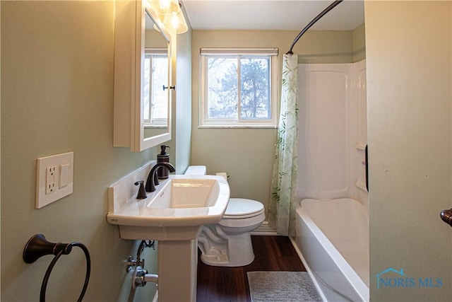 full bath with toilet, shower / bath combo with shower curtain, and wood finished floors