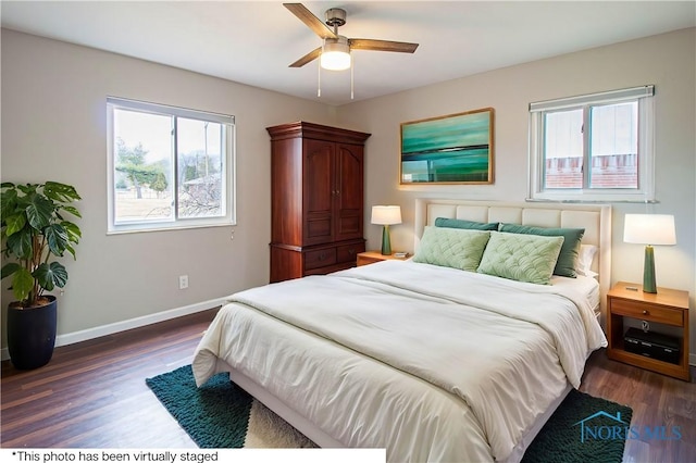 bedroom with a ceiling fan, baseboards, and dark wood-type flooring