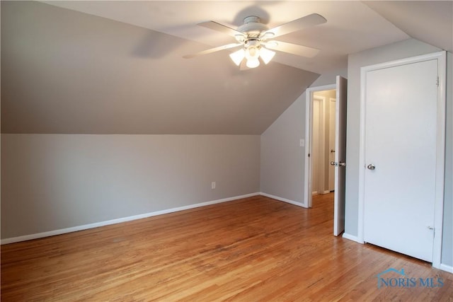 bonus room featuring a ceiling fan, light wood-type flooring, lofted ceiling, and baseboards