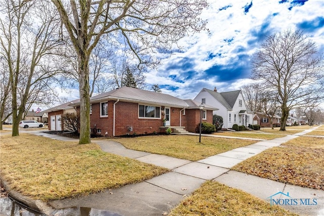 ranch-style house with a garage, a front lawn, and brick siding