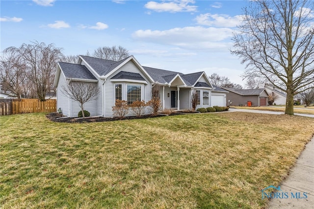 ranch-style house with an attached garage, fence, concrete driveway, and a front yard