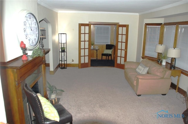 sitting room featuring carpet floors, french doors, and crown molding