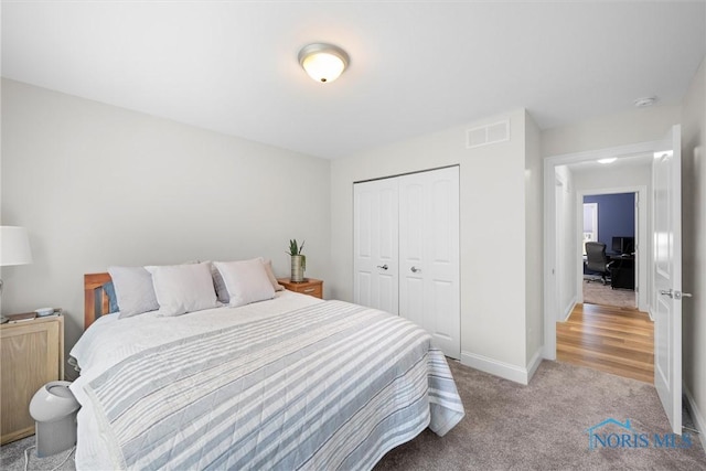 bedroom featuring light carpet, a closet, visible vents, and baseboards