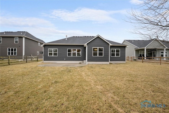 back of house with a patio area, a lawn, and a fenced backyard