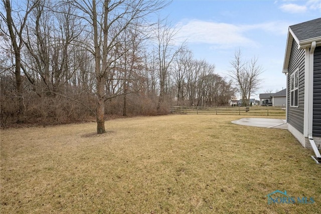 view of yard with fence and a patio