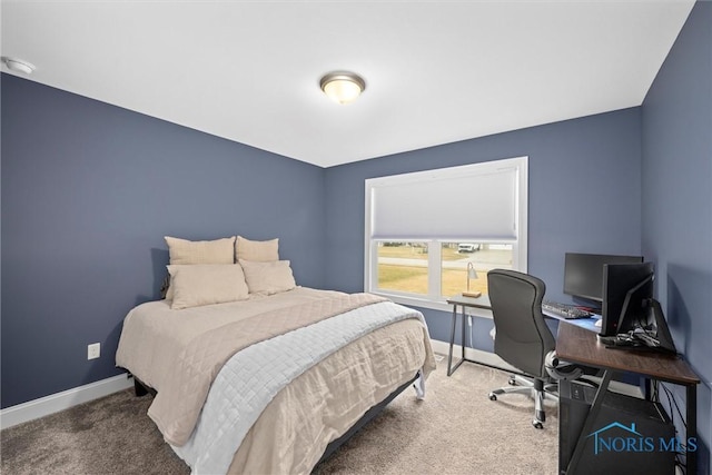 carpeted bedroom featuring baseboards