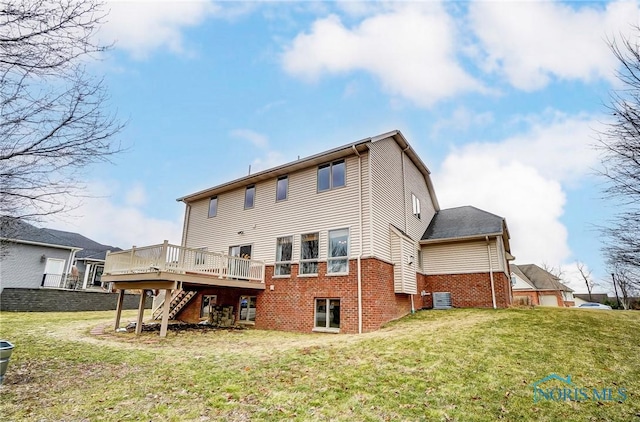 rear view of property featuring central AC unit, a lawn, stairway, a deck, and brick siding