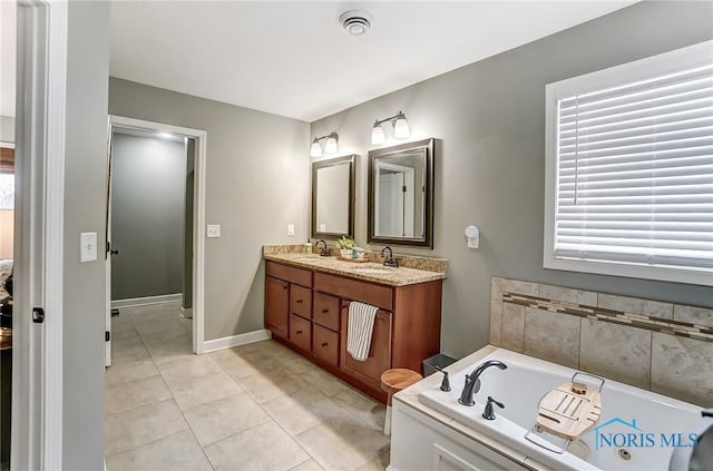 full bathroom featuring double vanity, a garden tub, a sink, and tile patterned floors