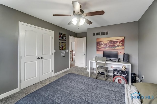 office area featuring carpet floors, visible vents, ceiling fan, and baseboards