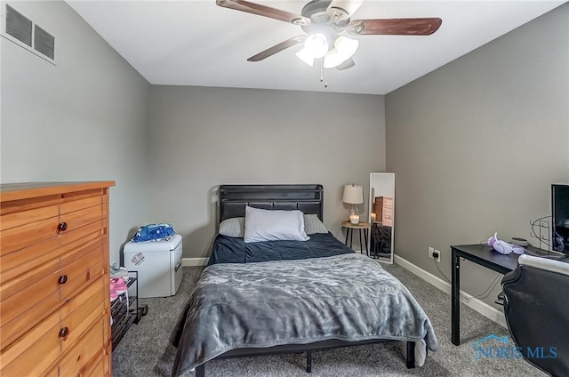 carpeted bedroom with baseboards, visible vents, and ceiling fan