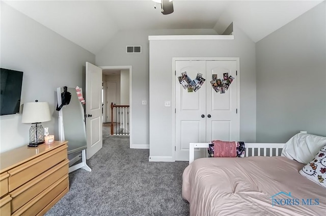 bedroom with baseboards, visible vents, lofted ceiling, carpet flooring, and a closet