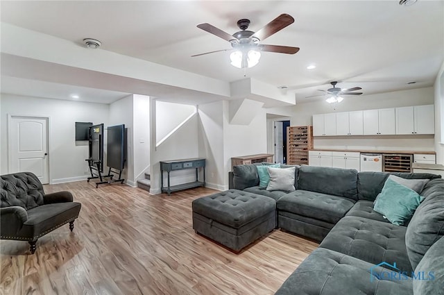 living room with stairs, recessed lighting, light wood-type flooring, and baseboards