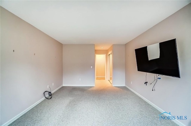 unfurnished living room with carpet floors and baseboards