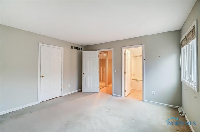 unfurnished bedroom featuring carpet, connected bathroom, visible vents, and baseboards