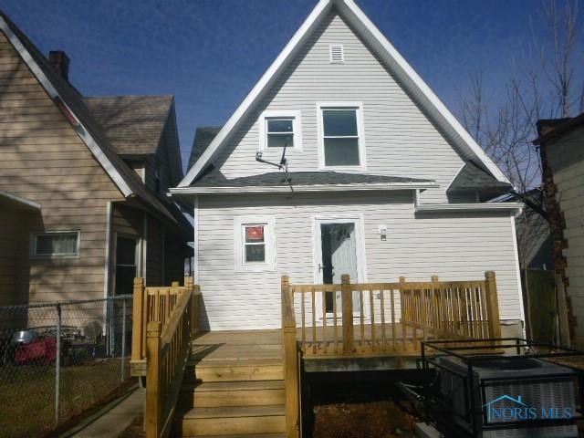 back of house with a wooden deck and fence