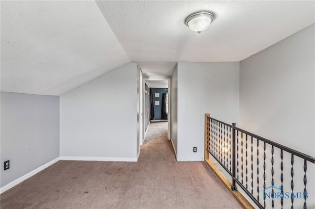 bonus room with baseboards, a textured ceiling, carpet, and lofted ceiling