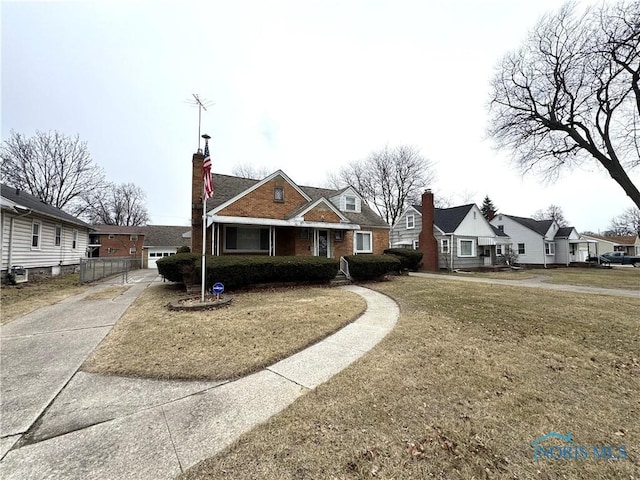 view of front of property with brick siding, a chimney, a front lawn, and a residential view