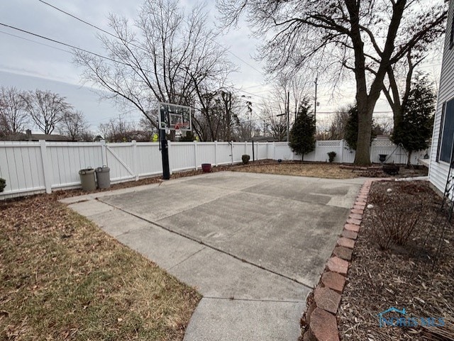 view of sport court featuring basketball court and a fenced backyard