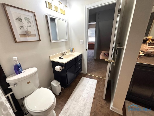 bathroom with toilet and vanity