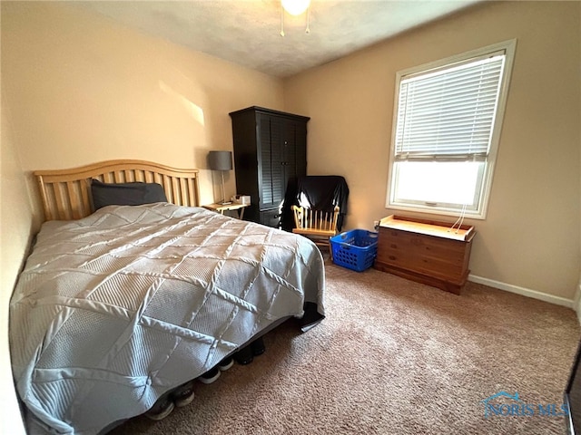 carpeted bedroom featuring baseboards