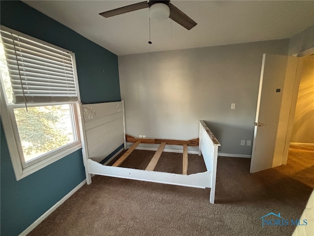 unfurnished bedroom featuring carpet flooring, baseboards, and ceiling fan