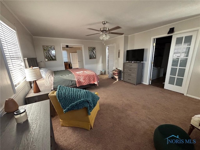 bedroom with crown molding, carpet, baseboards, and ceiling fan