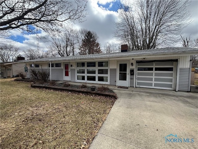 single story home featuring a garage, a chimney, concrete driveway, and roof with shingles