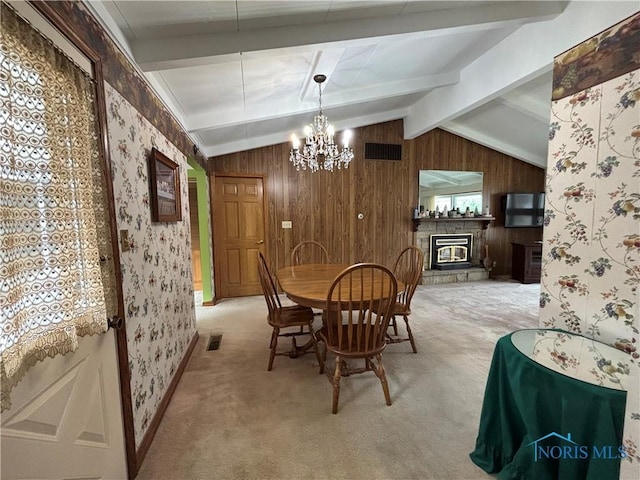 dining area with vaulted ceiling with beams, a fireplace, light colored carpet, visible vents, and wallpapered walls