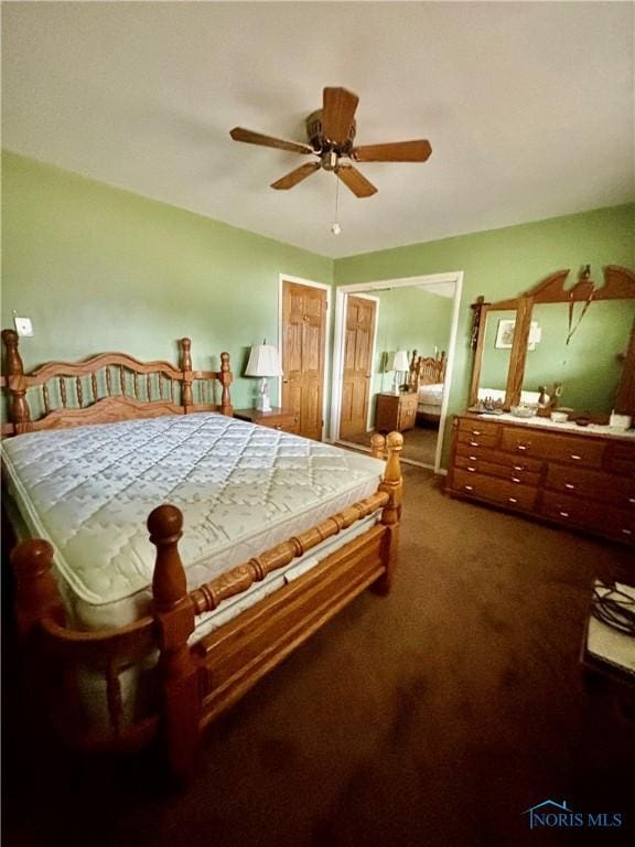 bedroom with dark carpet and ceiling fan