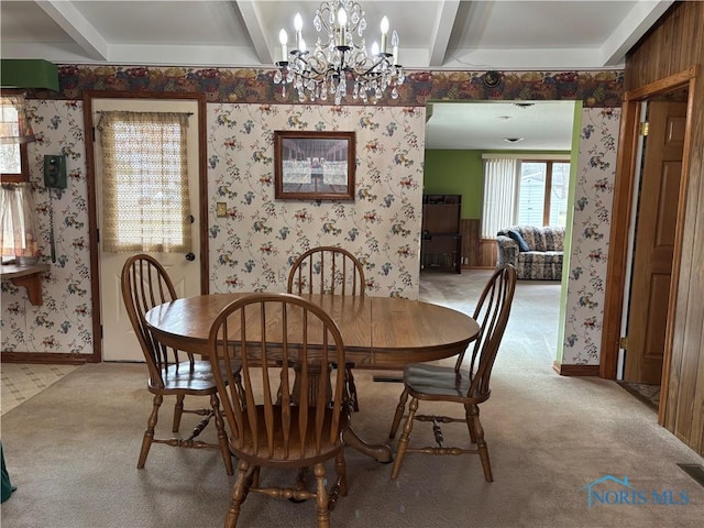 dining area featuring carpet floors, beam ceiling, and wallpapered walls